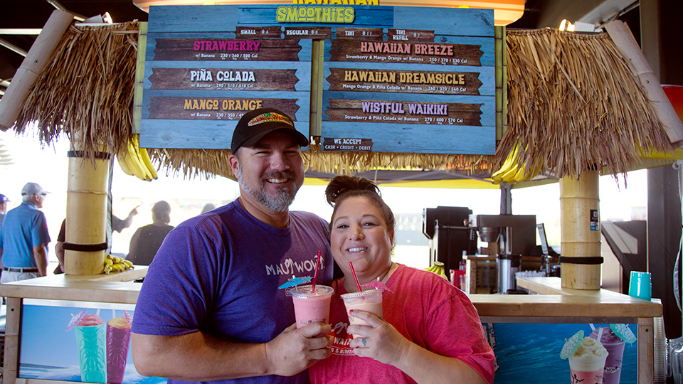 Maui Wowi employees with smoothies, in front of K-Cart